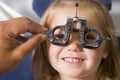 Optometrist in exam room with young girl Royalty Free Stock Photo