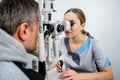 Optometrist examining the eyes of a male patient in a modern ophthalmology clinic. Eye doctor with man patient during an Royalty Free Stock Photo