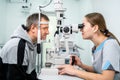 Optometrist examining the eyes of a male patient in a modern ophthalmology clinic. Eye doctor with man patient during an Royalty Free Stock Photo