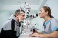 Optometrist examining the eyes of a male patient in a modern ophthalmology clinic. Eye doctor with man patient during an Royalty Free Stock Photo