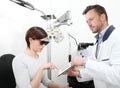 Optometrist examining eyesight woman patient in optician office Royalty Free Stock Photo