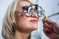 Optometrist examining female patient with messbrille