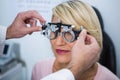 Optometrist examining female patient with messbrille