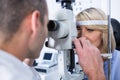 Optometrist examining female patient on slit lamp Royalty Free Stock Photo