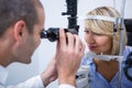 Optometrist examining female patient on slit lamp Royalty Free Stock Photo