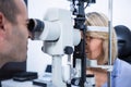 Optometrist examining female patient on slit lamp Royalty Free Stock Photo