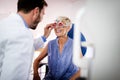 Optometrist examining senior woman in modern ophthalmology clinic Royalty Free Stock Photo