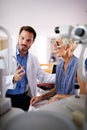 Optometrist examining senior woman in modern ophthalmology clinic Royalty Free Stock Photo