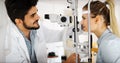 Optometrist examining patient in modern ophthalmology clinic Royalty Free Stock Photo