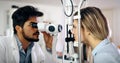 Optometrist examining patient in modern ophthalmology clinic Royalty Free Stock Photo