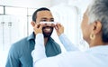 Optometrist woman, man and frame for eye exam, check and lens for vision, wellness and health in clinic. Doctor Royalty Free Stock Photo