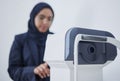 Optometry, ophthalmology and Muslim woman with a machine for vision correction and surgery. Test, technology and Royalty Free Stock Photo