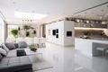 Opulent interior design with a white kitchen, dining, and living area Royalty Free Stock Photo