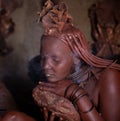 A traditional himba tribe woman doing her beauty procedure