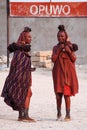 Opuwo, Namibia - Jul 06, 2019: Himba women with the typical necklace and hairstyle in the streets of Opuwo