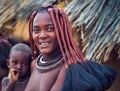 Portrait of a young himba woman with her child wearing traditional hairstyle