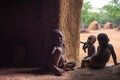 Three children of the Himba tribe in Namibia play in their hut Royalty Free Stock Photo