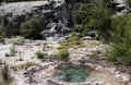 Orakei Korako hidden geothermal valley: View on cascade with steaming hot clear blue alkali chloride thermal pool Royalty Free Stock Photo