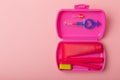 Oral care. Set of toothbrushes,toothpaste and brush on pink background. Royalty Free Stock Photo