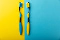 Oral care. Toothbrushes on a yellow-blue background. Royalty Free Stock Photo