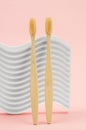 Two bamboo toothbrushes on a pink background. Eco-friendly toothbrushes. Dental eco friendly concept Royalty Free Stock Photo