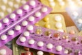 Oral contraceptive pill on pharmacy counter with colorful pills