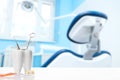 Oral dental hygiene. Healthy white tooth and dentist mirror with explorer probe instrument near toothbrush against blurred dentist Royalty Free Stock Photo