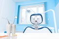 Oral dental hygiene. Healthy white tooth and dentist mirror with explorer probe instrument near toothbrush against blurred dentist Royalty Free Stock Photo