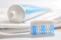 Oral health and dental hygiene concept with a toothbrush covered in toothpaste with the toothpaste tube in defocused in the