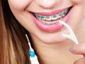 Woman with braces cleaning teeth with toothbrush