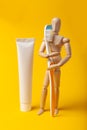 Oral hygiene and dental care. Wooden man holds toothbrush and toothpaste