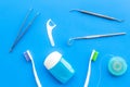 Daily oral hygiene for family. Toothbrush, dental floss and dentist instruments on blue background top view