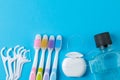 Oral hygiene. multicolored toothbrush, dental floss and mouthwash on a bright blue background. top view Royalty Free Stock Photo