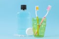 Oral hygiene. Toothbrush, dental floss and rinse for mouth and teeth on a gentle blue background Royalty Free Stock Photo