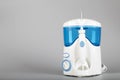 Oral irrigator on a gray background.