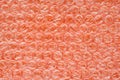 Orange air bubble wrap close up. Plastic surface of shock proof Royalty Free Stock Photo