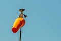 Orange airport windsock with blue sky Royalty Free Stock Photo