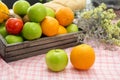Orange and apple in a wooden crate. Fresh fruit on a wooden table with a cloth. Eating fruit helps to lose weight. fruits and veg Royalty Free Stock Photo