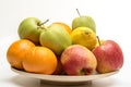 Orange, apples and banana on the wooden plate Royalty Free Stock Photo
