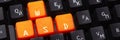 Orange arrow keys on a black keyboard, up, down, left, right buttons on a gaming computer keyboard Royalty Free Stock Photo