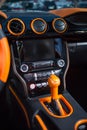 Orange automatic shifter and the front panel of the salon inside the car. Royalty Free Stock Photo