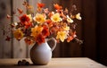 Orange autumnal flowers in vase and lit candle on wooden background