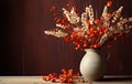 Orange autumnal flowers in vase and lit candle on wooden background