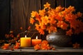 Orange autumnal flowers in vase and lit candle on wooden background