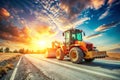 Orange Backhoe Loader on a Construction Road with a Bright Sunset Sky and Extended Arm vehicle Royalty Free Stock Photo