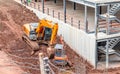 The orange backhoe and Mini excavator is on the ground at site construction