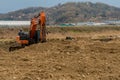 Orange backhoe sitting idle