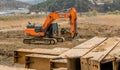 Orange backhoe sitting idle