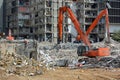 Orange Backhoes Demolish Building