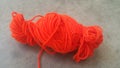 Orange ball of threads wool yarn for knitting on grey floor background Royalty Free Stock Photo